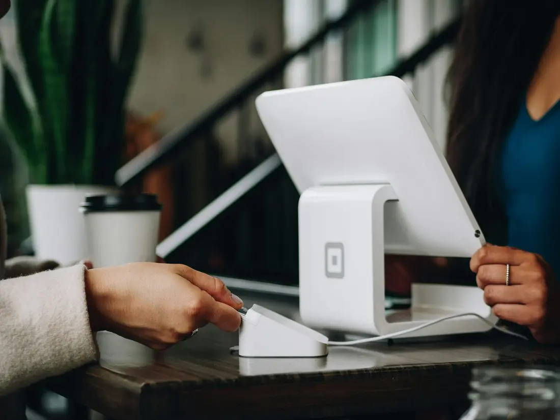 A guest paying at a front desk terminal