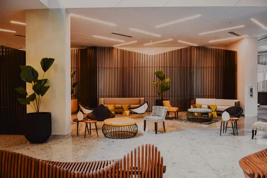 A warmly lit hotel lounge with lounge chairs